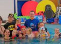 Local swimming teacher leads babies’ splashathon event for good causes