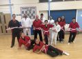 Martial arts students wear pink belts for breast cancer charity