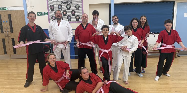 Martial arts students wear pink belts for breast cancer charity